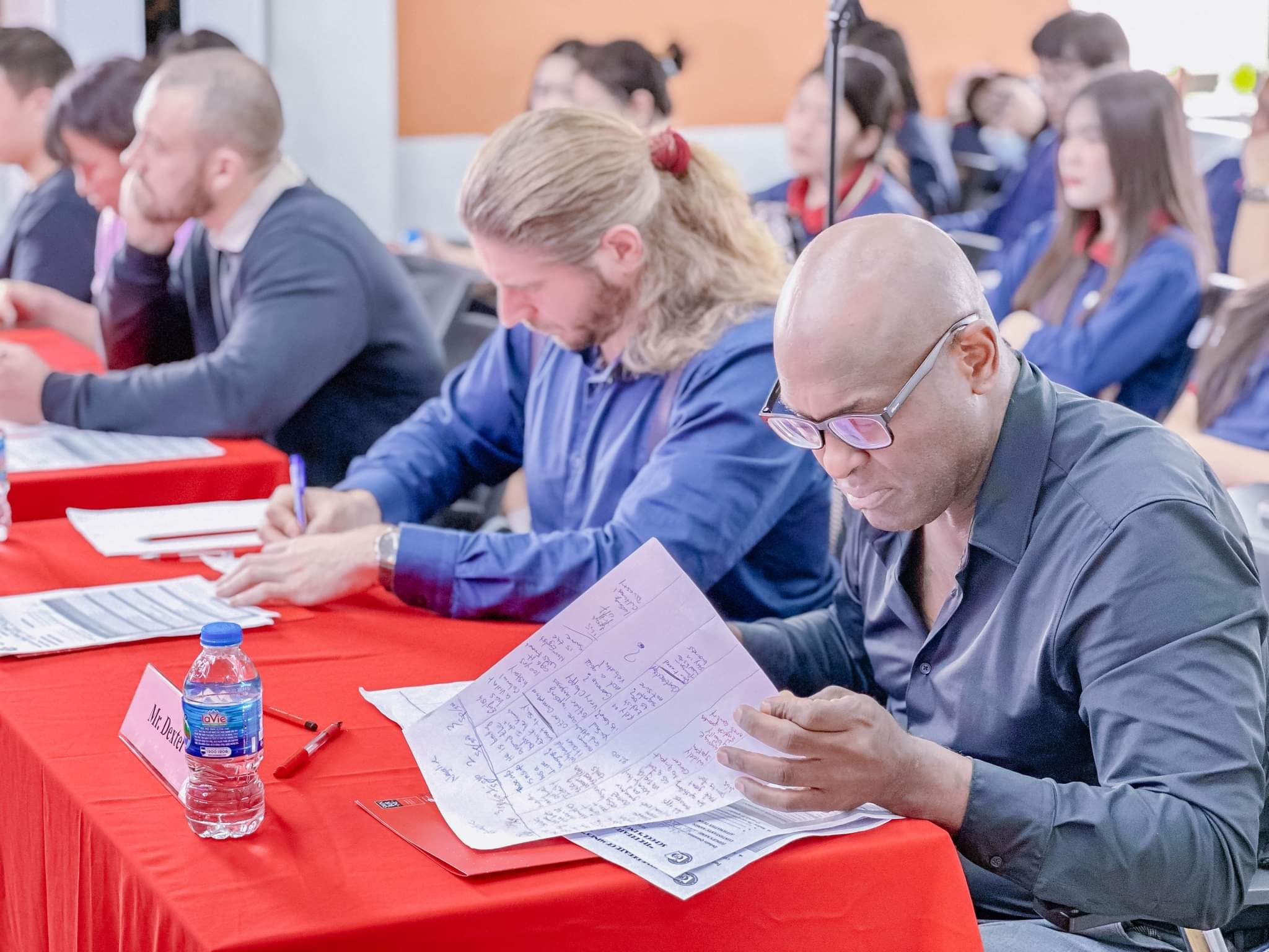 Students engaged in Socratic seminar inside a classic library setting